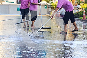 Adult cleaner maid woman with mop and uniform cleaning corridor