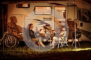 Adult couple clinking glasses of wine. Family vacation travel RV, holiday trip in motorhome, Caravan car Vacation photo