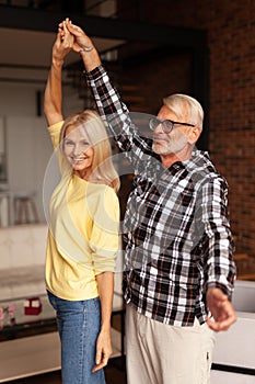 Adult couple of people dancing in home interior. Happy moments in life. Romantic relationship, affection