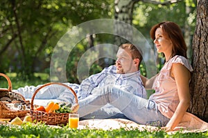 Adult couple picnicking in park