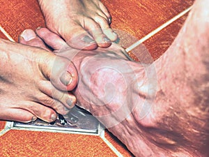 Couple playing in shower, feet on rural floor