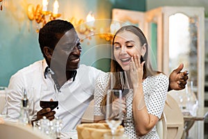 Adult couple on romantic date drinking red wine at restaurant