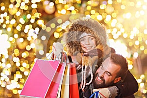Adult couple shopping in the city during Christmas time