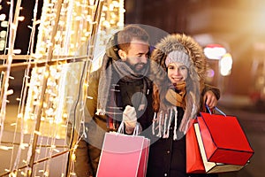 Adult couple shopping in the city during Christmas time