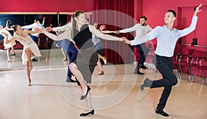 Adult dancing couples enjoying active swing