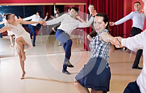 Adult dancing couples enjoying active swing