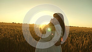 Adult daughter in arms of her mother in a field in the rays of the sun. mom strokes her daughter`s hair. Mom gently hugs