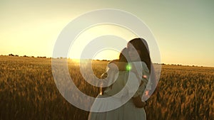 Adult daughter in arms of her mother in a field in the rays of the sun. mom strokes her daughter`s hair. Mom gently hugs