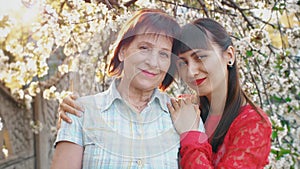 Adult daughter hugging her senior mother