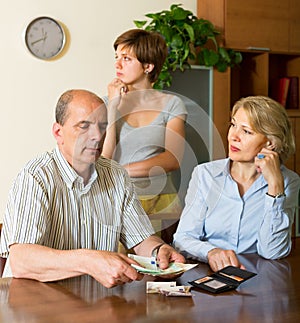 Adult daughter and parents with money