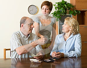 Adult daughter and parents with money