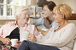 Adult Daughter With Teenage Granddaughter Visiting Grandmother