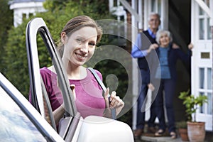 Adult Daughter Visiting Senior Parents At Home