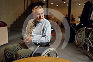 Adult disabled man in wheelchair, cafeteria