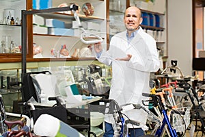 Adult doctor posing near orthopaedic equipment