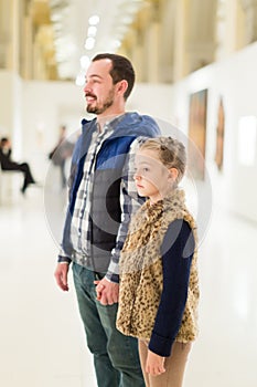 Adult father and daughter enjoying expositions
