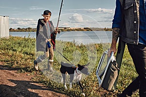 Adult father and teenager son going to fishing together.