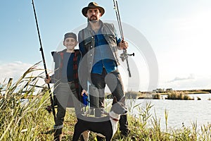 Adult father and teenager son going to fishing together.