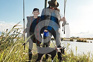 Adult father and teenager son going to fishing together.