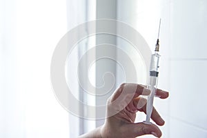 Adult female doctor hold the syringe