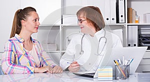 Adult female doctor leading medical appointment