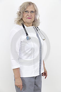 Adult female doctor with a stethoscope against a white wall. experienced doctor who inspires confidence. Woman hospital worker