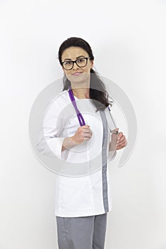 Adult female doctor with a stethoscope against a white wall. experienced doctor who inspires confidence. Woman hospital worker