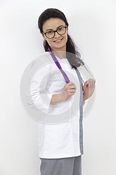 Adult female doctor with a stethoscope against a white wall. experienced doctor who inspires confidence. Woman hospital worker