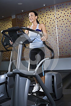 Adult female on elliptical machine.