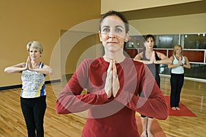 Adult females in yoga class.