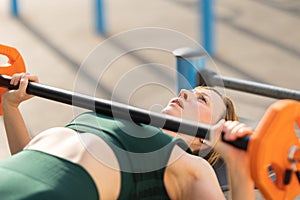 Adult fitness woman training her hands with lifting dumbbell