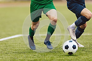 Adult football competition. Soccer football player dribbling a ball and kick a ball during match in the stadium