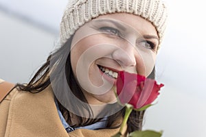 Portrait of an adult girl smelling a rose