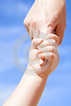 Adult giving hand to a child