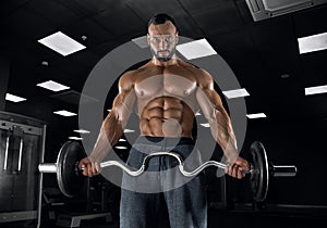 Adult guy bodybuilder posing in gym