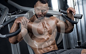 Adult guy bodybuilder posing in gym