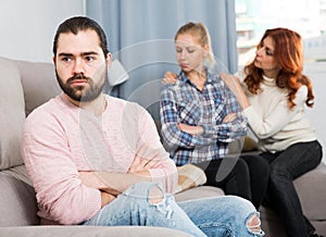 Adult guy having argue with wife and mother-in-law