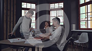 Adult guy holding two cups coming in office