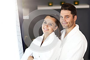 Adult happy couple relaxing in spa salon