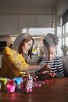 Adult helping child with craft project