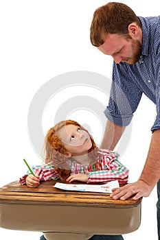 Adult helping School Child at Desk