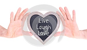 Adult holding heart shaped chalkboard - Live laugh love