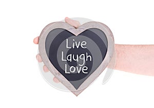 Adult holding heart shaped chalkboard - Live laugh love