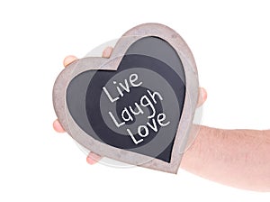 Adult holding heart shaped chalkboard - Live laugh love