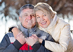 Adult husband and wife resting together outdoors