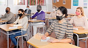 Adult Korean woman in protective mask at refresher course