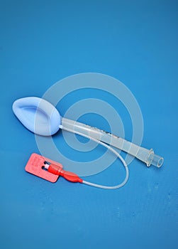 An adult laryngeal mask airway (LMA). Image isolated on blue background
