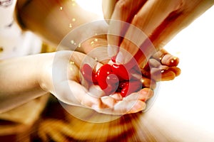 Adult and little child holding red hearts, and close up  on white background