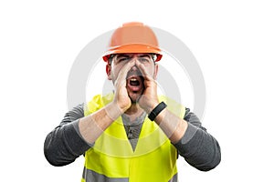 Adult male builder in work attire holding hands shouting gesture