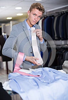 Adult male purchaser choosing tie